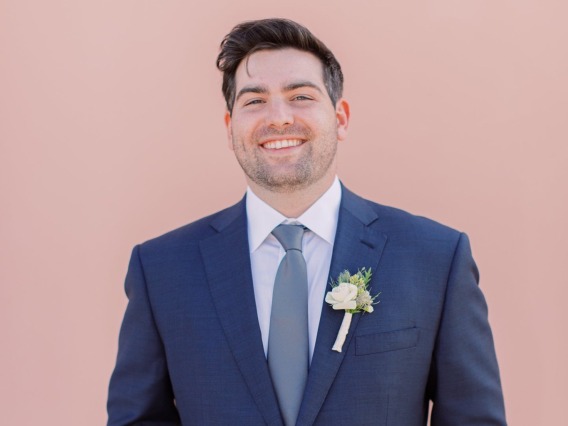 Benjamin Schwartz posing for photo in wedding suit