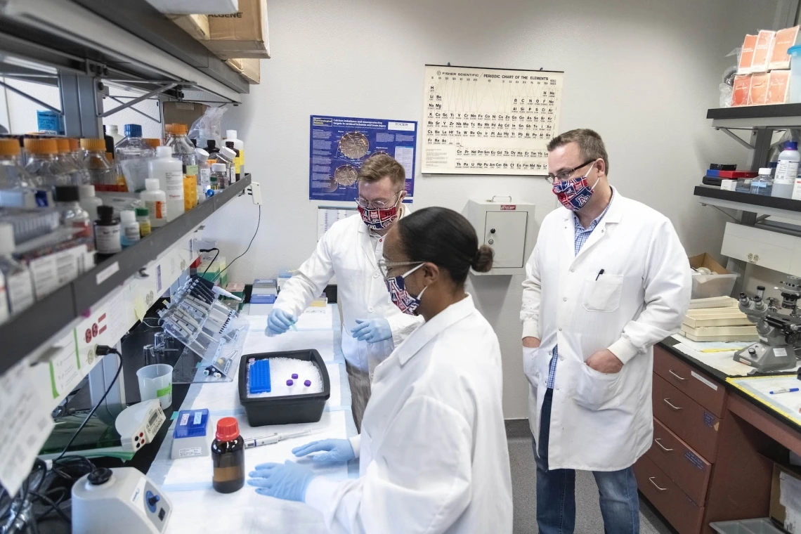Group of researchers working in a lab together