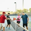 4 people playing pickleball